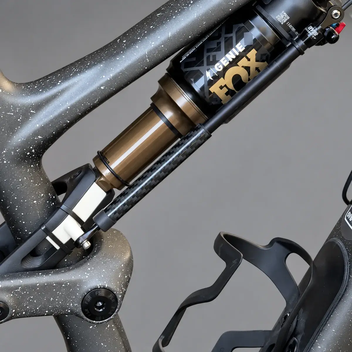 A Specialized Stumpjumper 15 with a linear sensor running from the printed link bracket alongside the Fox Genie rear shock, against a grey background.