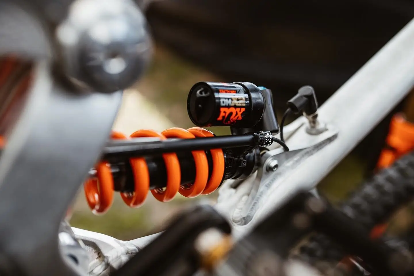 A custom BYB data acquisition system on a downhill mountain bike: a sensor alongside the coil shock, with its wiring run internally.