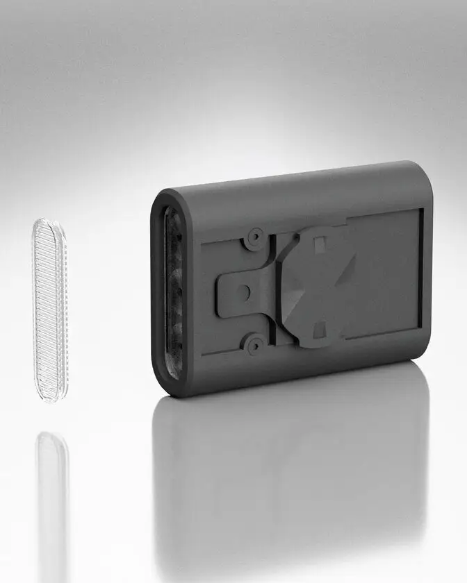 The clear BYB Focus StVZO lens standing beside the light body, which is turned to show its mounting face.