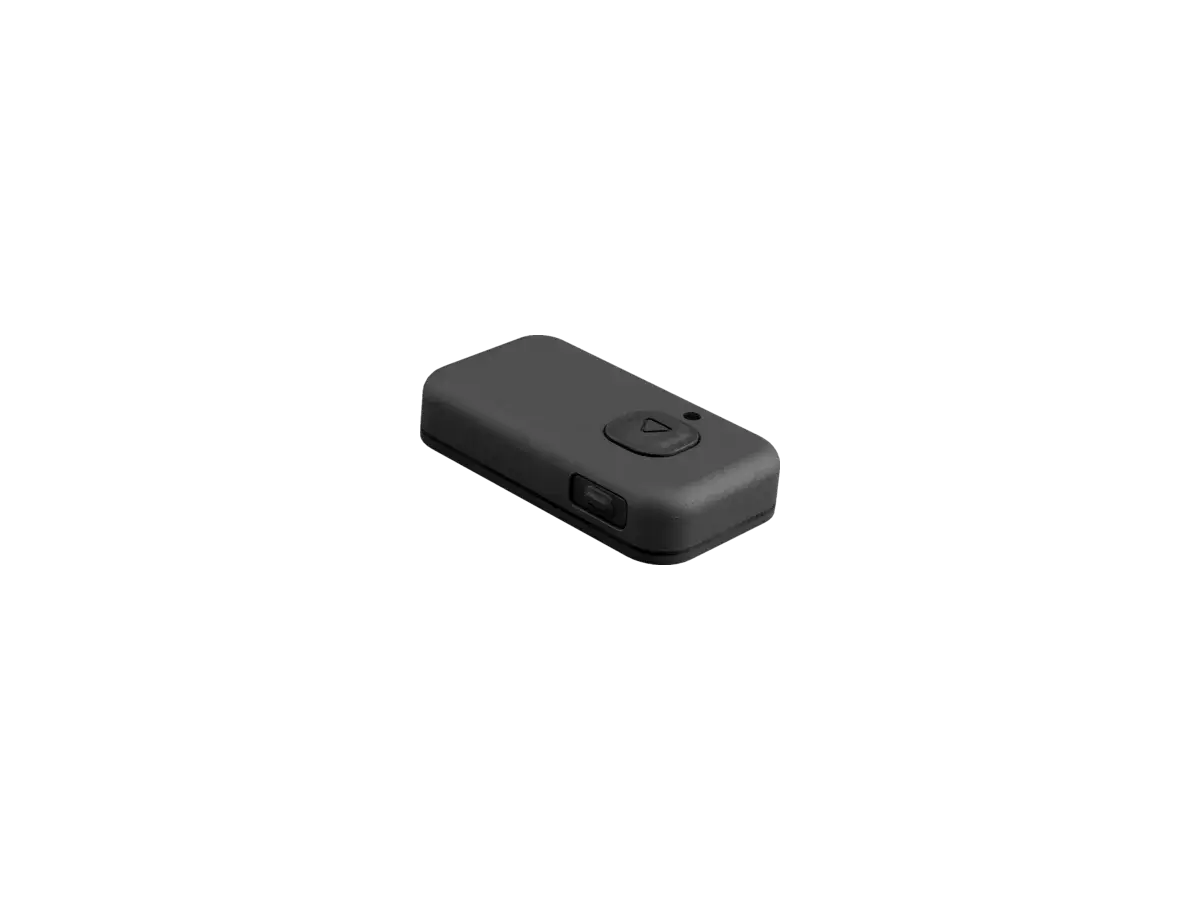 The BYB Focus external trigger: a small rounded remote with a single triangular button on its upper face and a second button on the side.