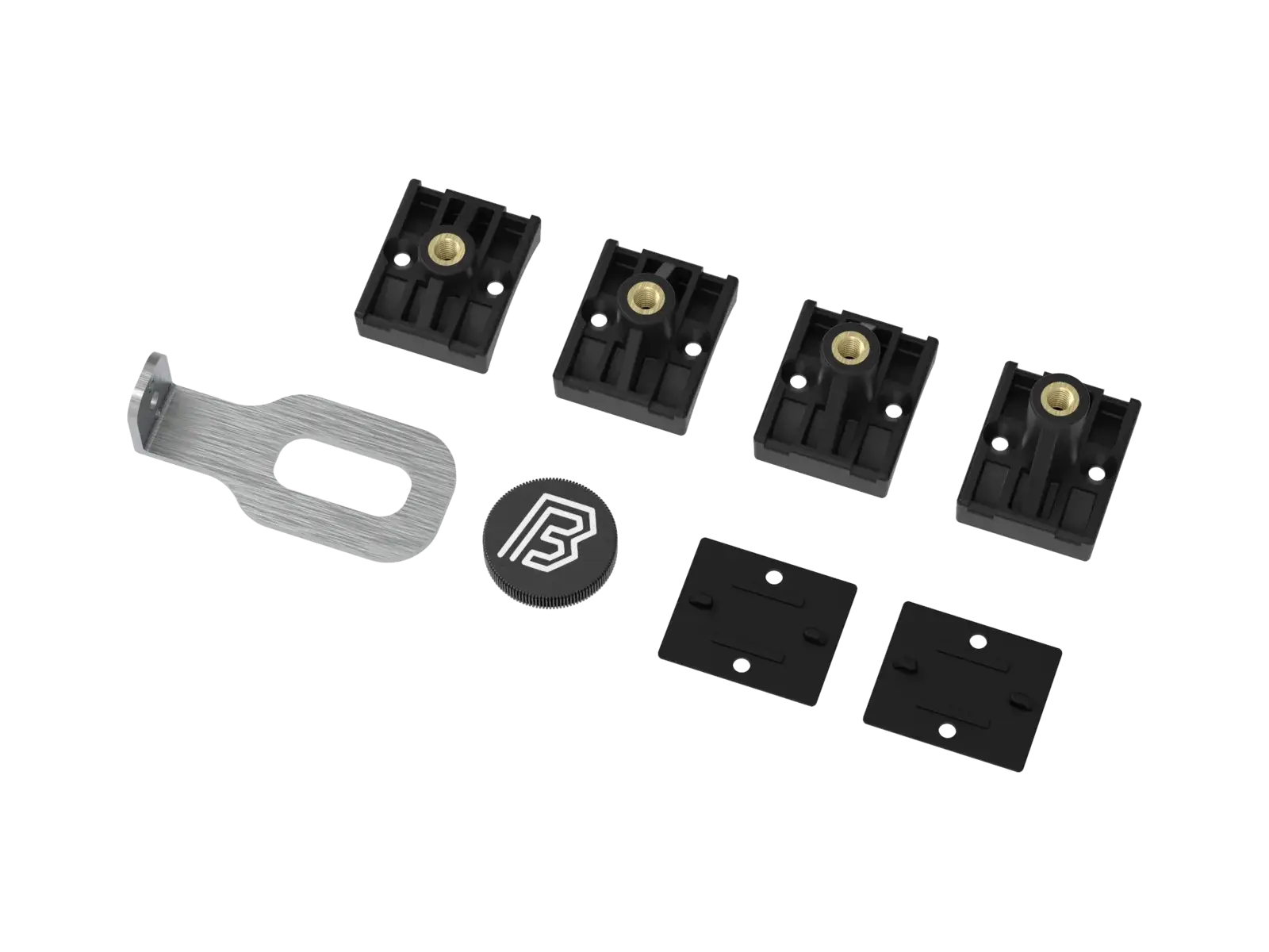 The MTB fork mounting kit from a third angle, showing the brass inserts set into the face of each plastic mounting.