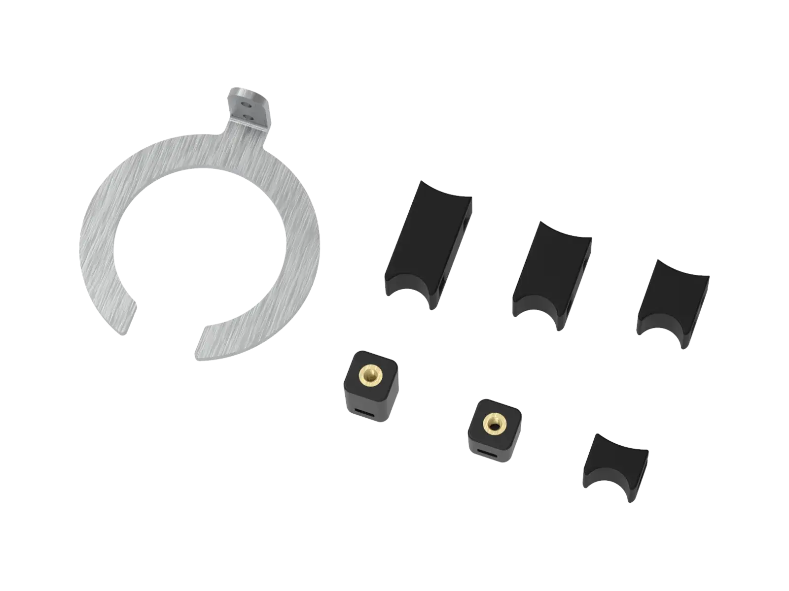 The MTB shock mounting kit from a second angle, the C-shaped steel bracket standing beside the curved plastic shims.