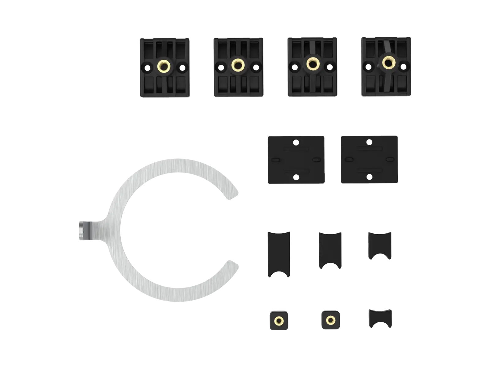 The MX mountings full kit laid out flat: four black plastic fork mountings with brass inserts, a slotted steel fork bracket, flat anti-slip pads, a C-shaped steel shock bracket and a set of curved plastic shock mountings.