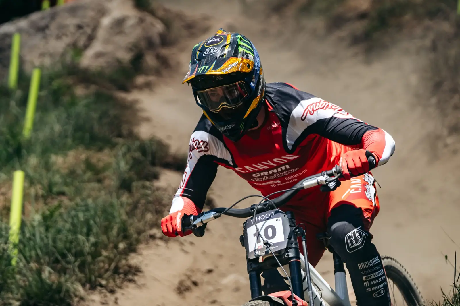A downhill racer mid-run on a dry track, with the acquisition unit mounted on the fork crown of the bike.