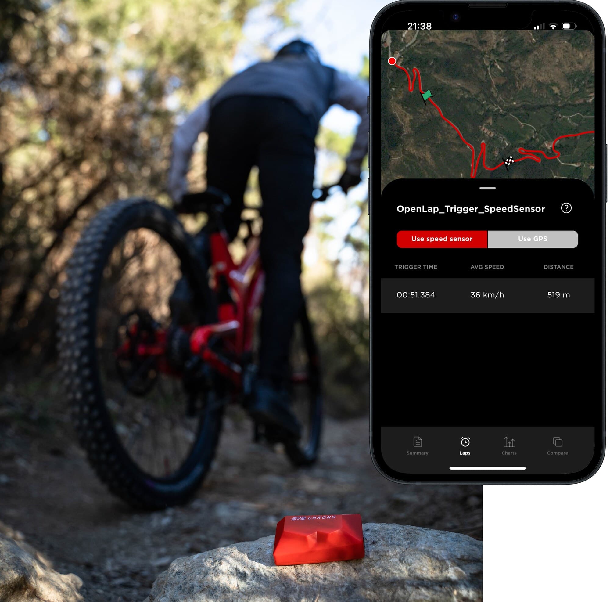 A red BYB Chrono coded trigger sitting on a rock beside a trail, with a rider riding away up the track and the app showing the lap it timed: 00:51.384 over 519 metres.