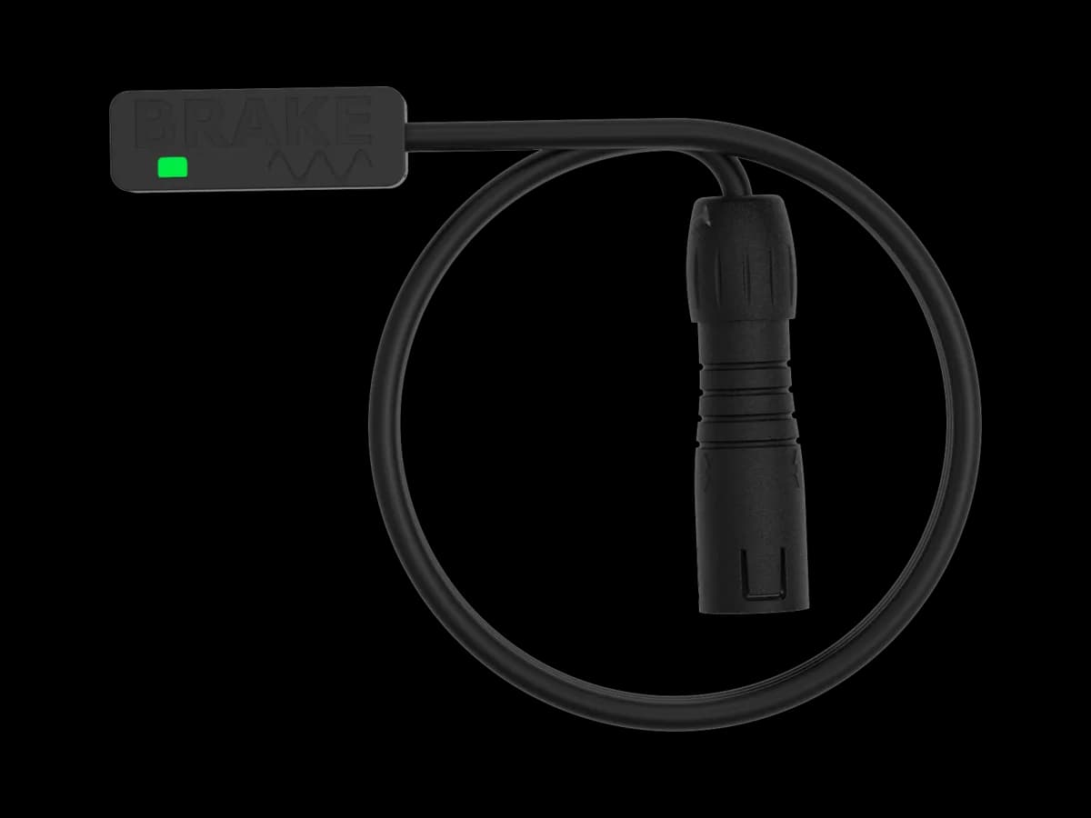 The BYB Tech analog brake sensor with a V3 connector: a slim body with SENSOR moulded into it and a green indicator, a coiled cable, and a straight all-plastic keyed plug on the end.