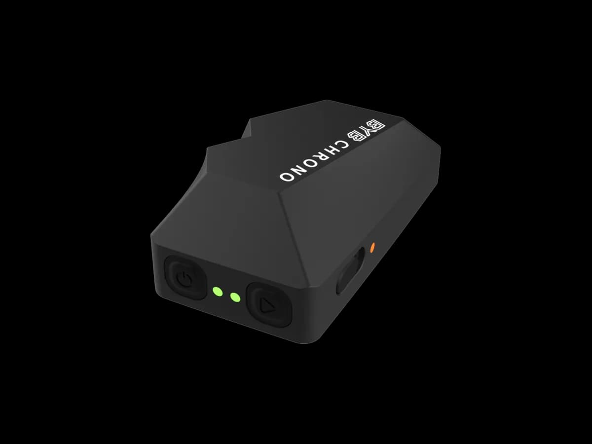 The BYB Chrono at three-quarters: a compact wedge-shaped black body marked BYB CHRONO, with a power button, a second button, two green lights and one amber light along the lower edge.