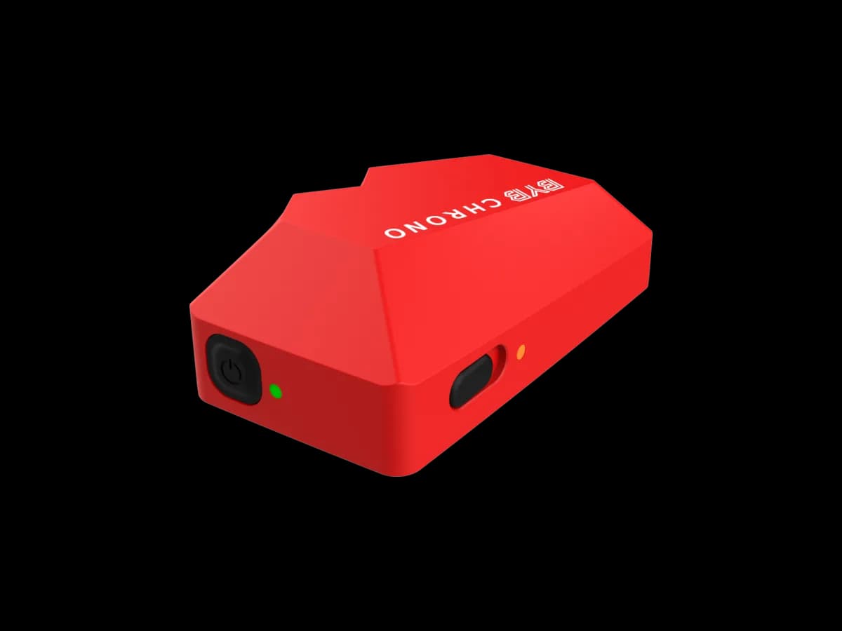 One red BYB Chrono external trigger beacon: the same wedge-shaped body as the timer, in red, with a power button, a green light and an amber light.