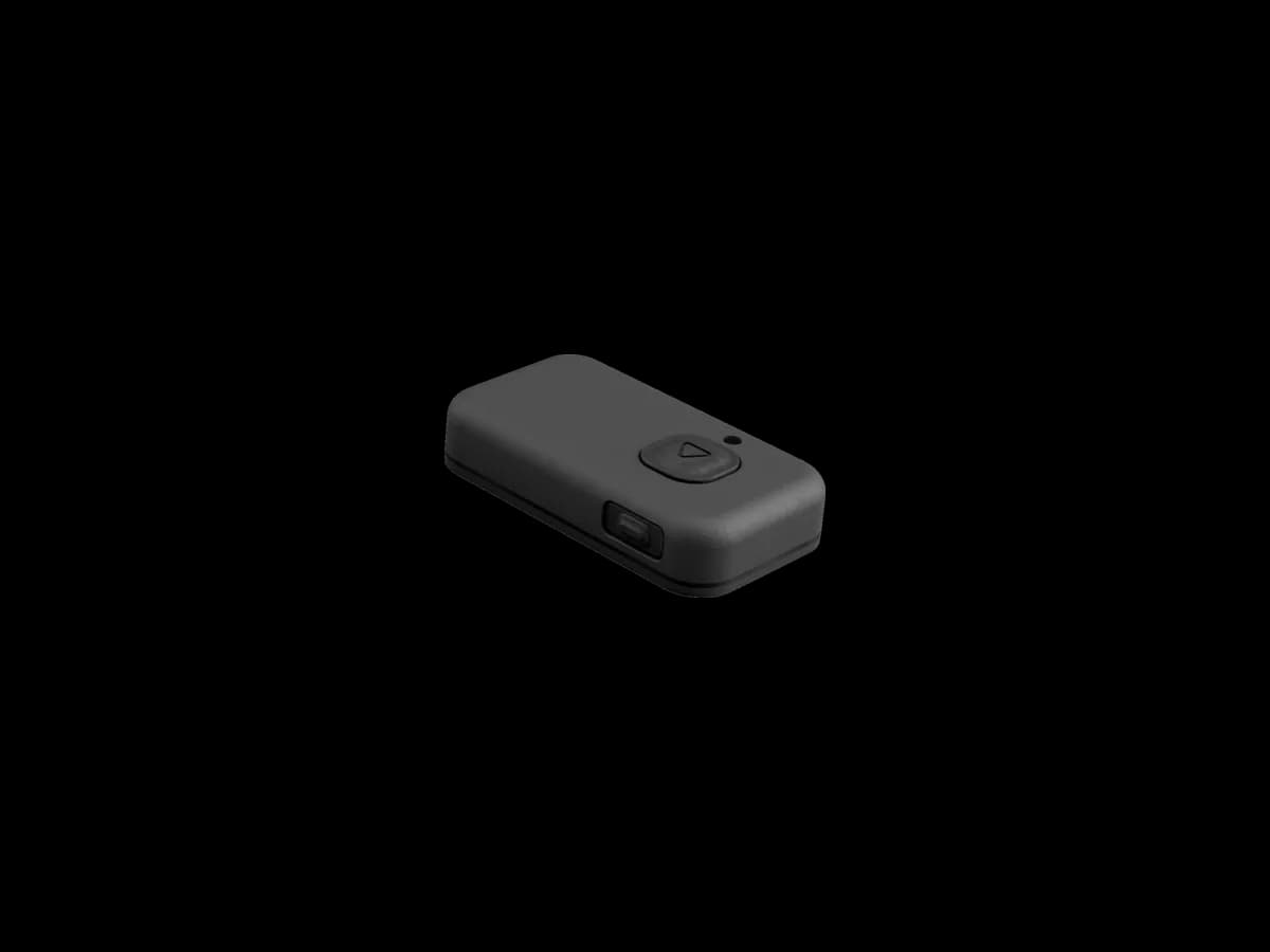 The BYB Focus external trigger: a small rounded remote with a single triangular button on its upper face and a second button on the side.