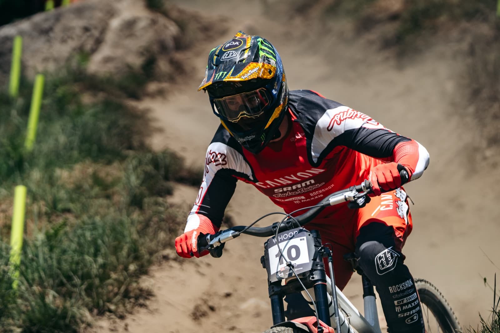 A downhill racer mid-run on a dry track, with the acquisition unit mounted on the fork crown of the bike.