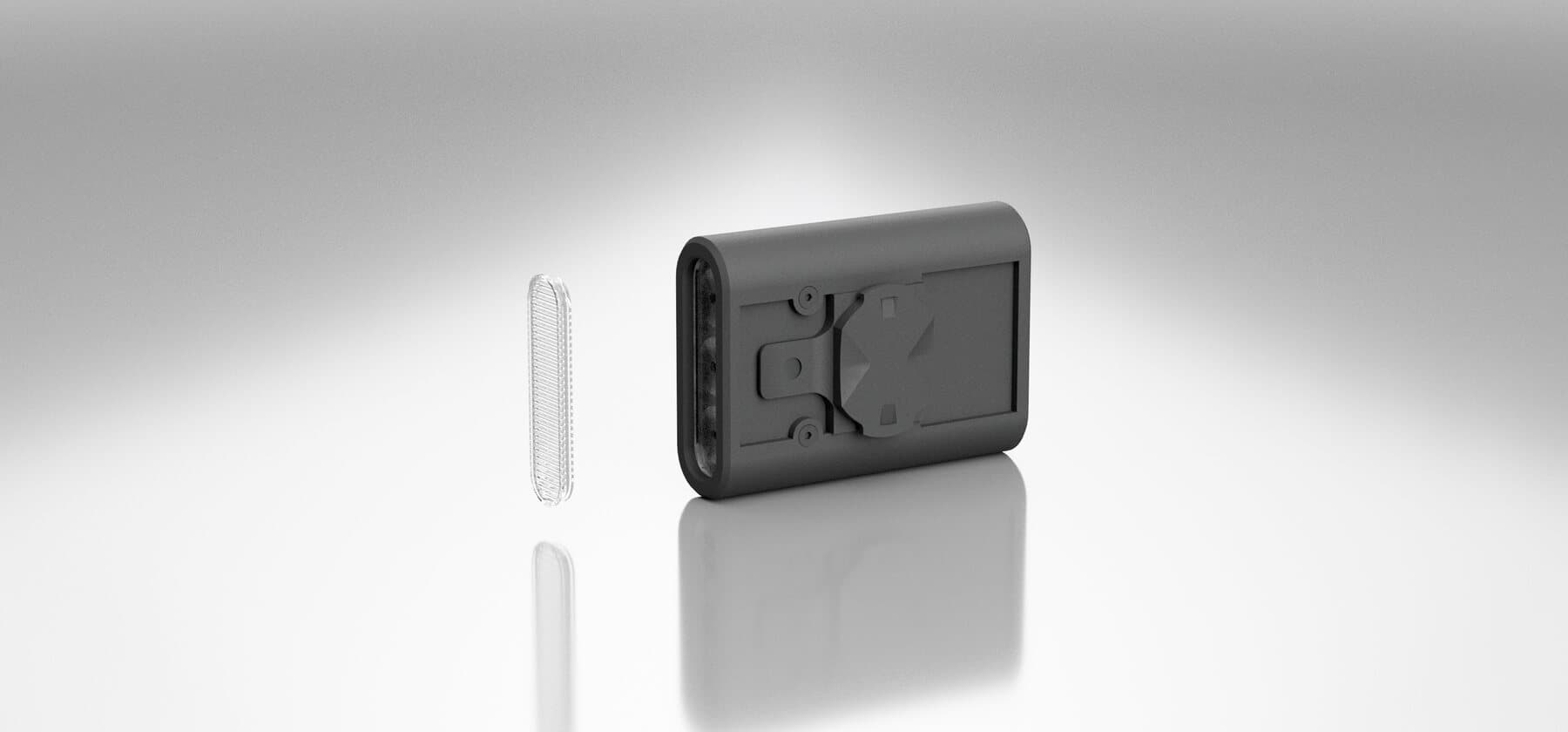 The BYB Focus StVZO lens lying beside the light body, which is turned to show its mounting face.
