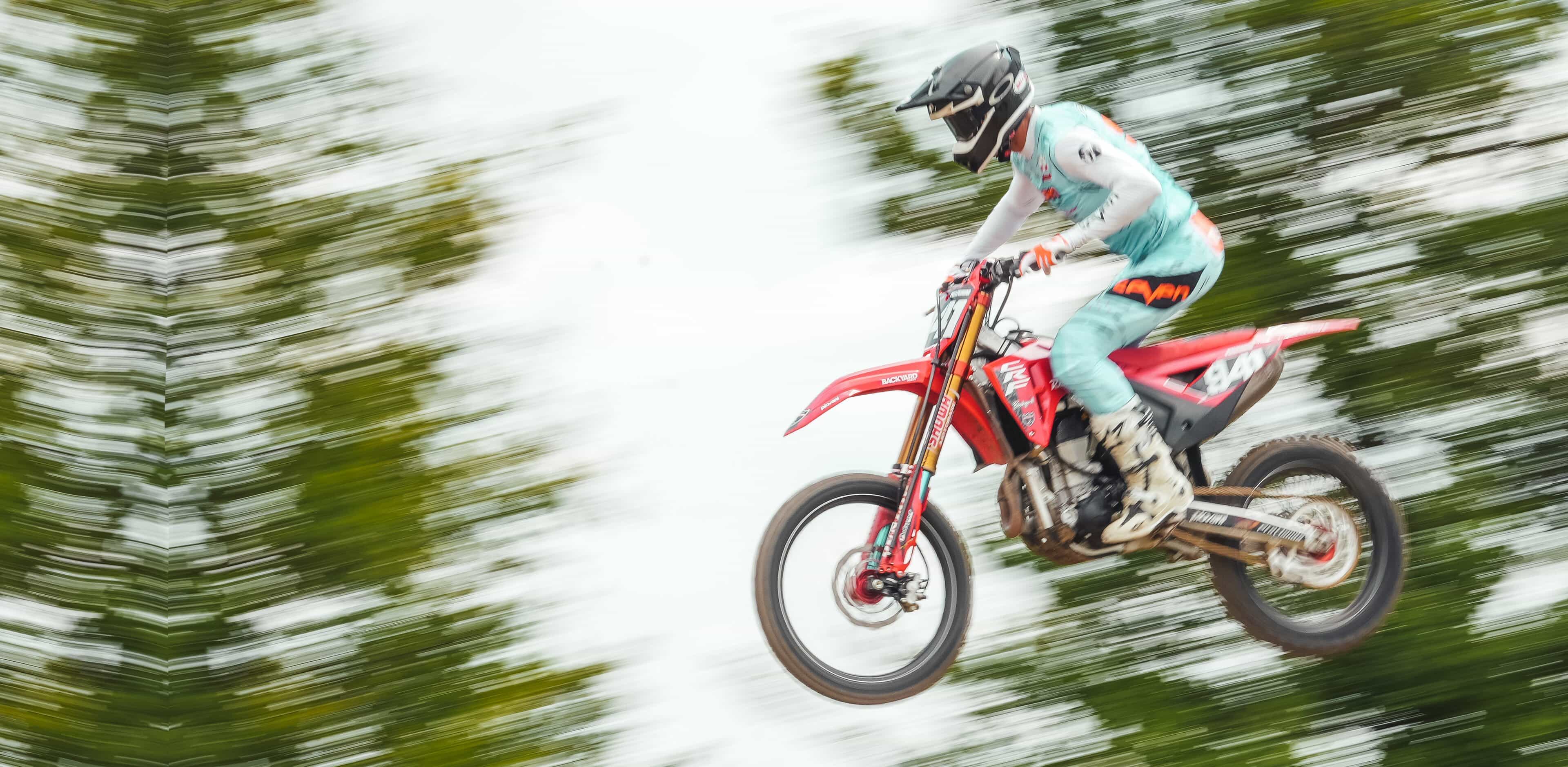 Angelo Pellegrini airborne over a supercross jump in Italy, BYB Telemetry sensors mounted down both fork legs of his motocross bike.